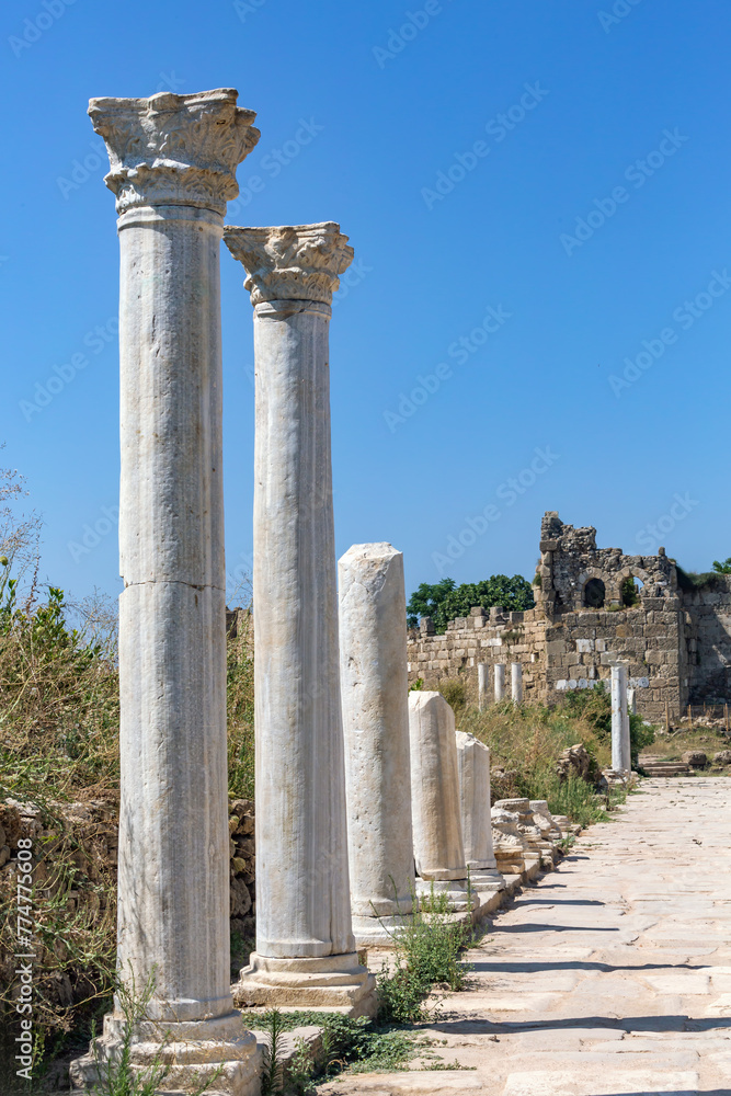 Ancient marble columns under clear blue sky in Side's ruins. Side, Antalya, Turkey (Turkiye) Ancient marble columns under clear blue sky in Side's ruins. Side, Antalya, Turkey (Turkiye)