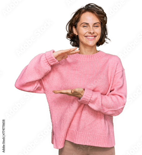 Young hispanic woman wearing casual clothes gesturing with hands showing big and large size sign, measure symbol. smiling looking at the camera. measuring concept.