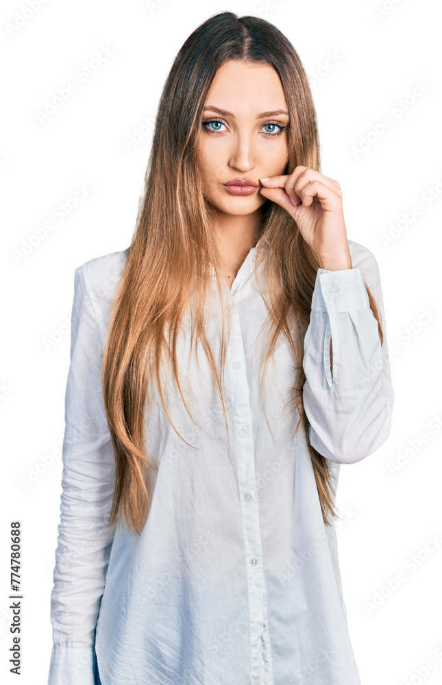 Beautiful caucasian woman wearing casual white shirt mouth and lips shut as zip with fingers. secret and silent, taboo talking Beautiful caucasian woman wearing casual white shirt mouth and lips shut as zip with fingers. secret and silent, taboo talking