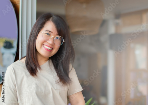 Free Download portrait of young adult business woman standing near the door of her own cafe, soft focus. - GFXLoad