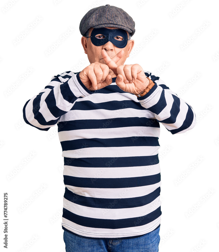 Senior handsome man wearing burglar mask and t-shirt rejection expression crossing fingers doing negative sign Senior handsome man wearing burglar mask and t-shirt rejection expression crossing fingers doing negative sign