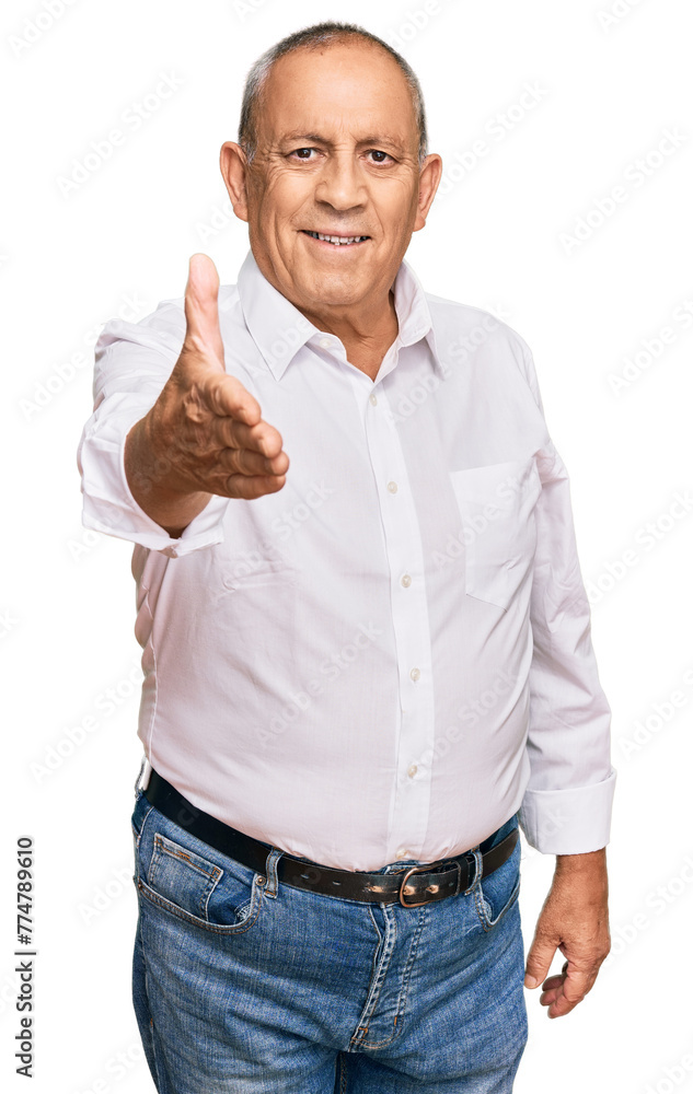 Handsome senior man wearing elegant white shirt smiling friendly offering handshake as greeting and welcoming. successful business. Handsome senior man wearing elegant white shirt smiling friendly offering handshake as greeting and welcoming. successful business.