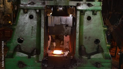 Large forging press metal piece shaping automatic drop hammer to give it a tool shape. Open die forging hit by hammer on a tool mould cast to form a machine component part isothermal weld factory	