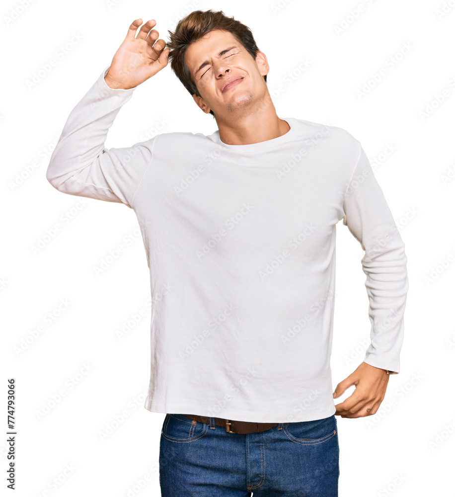 Handsome caucasian man wearing casual white sweater stretching back, tired and relaxed, sleepy and yawning for early morning Handsome caucasian man wearing casual white sweater stretching back, tired and relaxed, sleepy and yawning for early morning