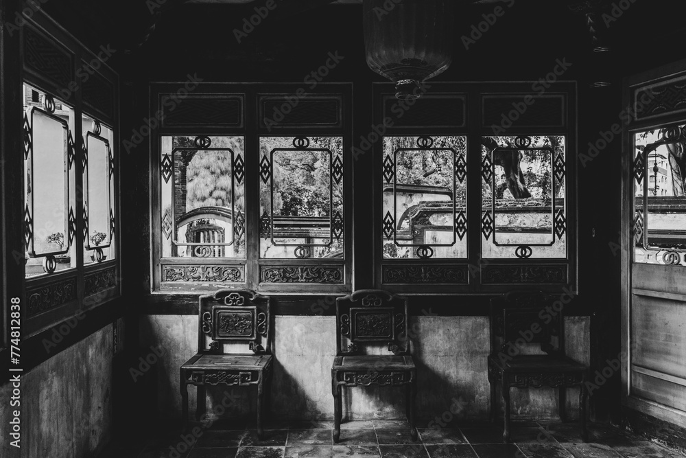 Naklejka premium Historic Chinese style building in Asia. Ancient historic wooden mansion in the center of the Asian capital Taipei. Interior old historic house in black and white with natural sun light Taipei Taiwan.