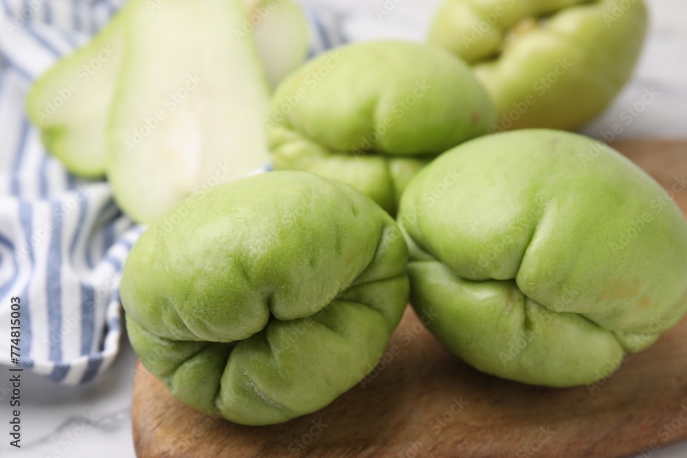 Many fresh green chayote on table, closeup Many fresh green chayote on table, closeup
