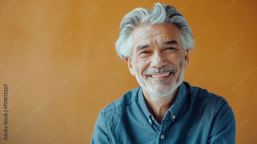 Senior European man with sophisticated charm dressed in expensive, but casual clothes on vibrant yellow background, copy space Senior European man with sophisticated charm dressed in expensive, but casual clothes on vibrant yellow background, copy space