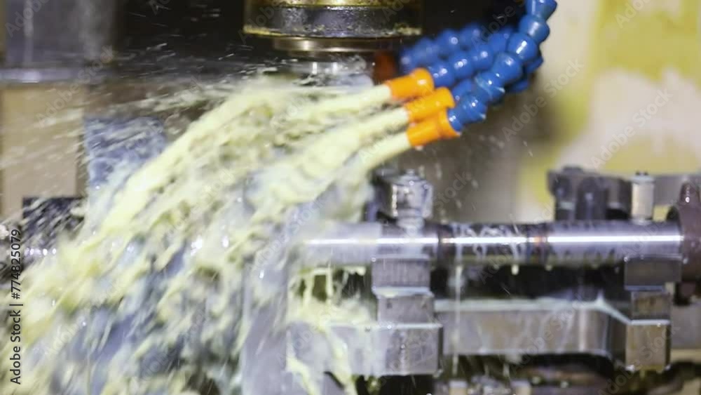 CNC turning machine high precision throwing coolant liquid on metal ...