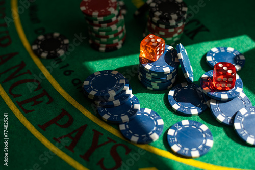 Blur background and chips, Stack of poker chips on a green table. Poker game theme © Angelov