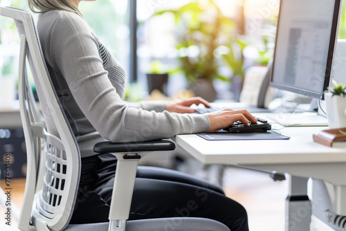 office person sit on chair with good posture to alleviate symptoms of office syndrome between working, ergonomic office furniture designed to promote better posture and mitigate the risk of injury photo