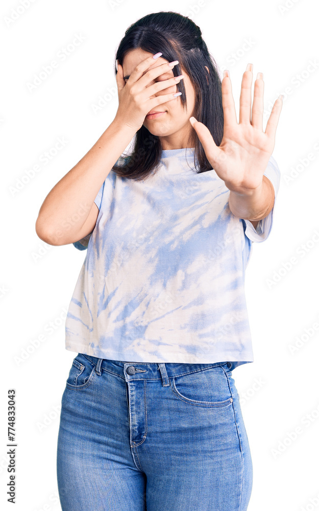 Young beautiful girl wearing casual t shirt covering eyes with hands and doing stop gesture with sad and fear expression. embarrassed and negative concept. Young beautiful girl wearing casual t shirt covering eyes with hands and doing stop gesture with sad and fear expression. embarrassed and negative concept.