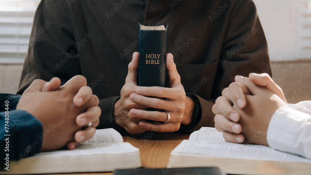 Christian man hands holding the holy bible to pray and worship God in the sunday morning.spirituality, religion,believe.Christian life.Studying the word of God in church.