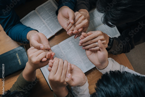 Christian group holding hands pray and worship god together on the sunday morning.spirituality, religion,believe.Christian life.Studying the word of God in church.