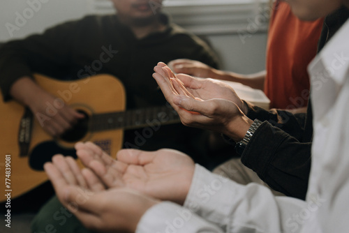 Group of christian people pray and worship God together in the sunday morning.Guitar,spirituality, religion,believe.Christian life.Studying the word of God in church.