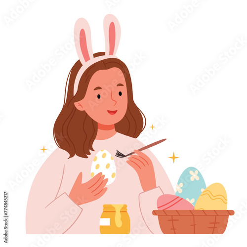 A girl paints an Easter egg. Happy Woman Preparing for Easter