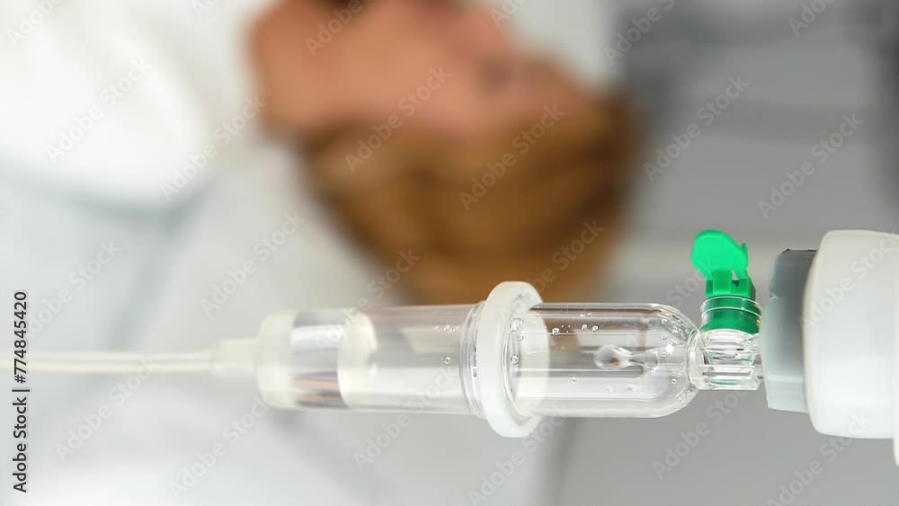 A young female patient in a hospital ward with a drip A young female patient in a hospital ward with a drip