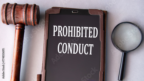 PROHIBITED CONDUCT - words on an electronic notepad with a judge's gavel in the background