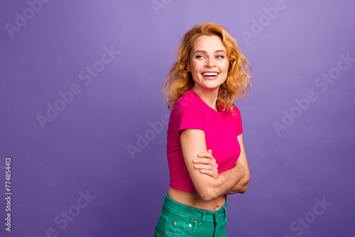 Photo of positive adorable woman wear trendy pink clothes crossed arms empty space isolated on purple color background © deagreez