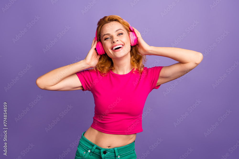 Photo of cheerful adorable nice woman wear stylish pink clothes enjoy listening music isolated on purple color background - obrazy, fototapety, plakaty 