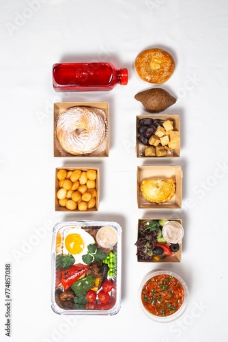 Top view of delicious dishes in containers on a white background. A set of oriental cuisine.