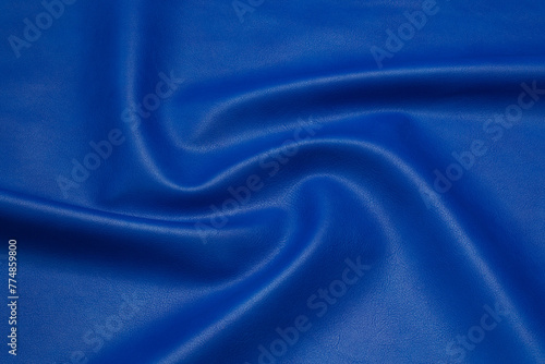 blue artificial leather with waves and folds on PVC base