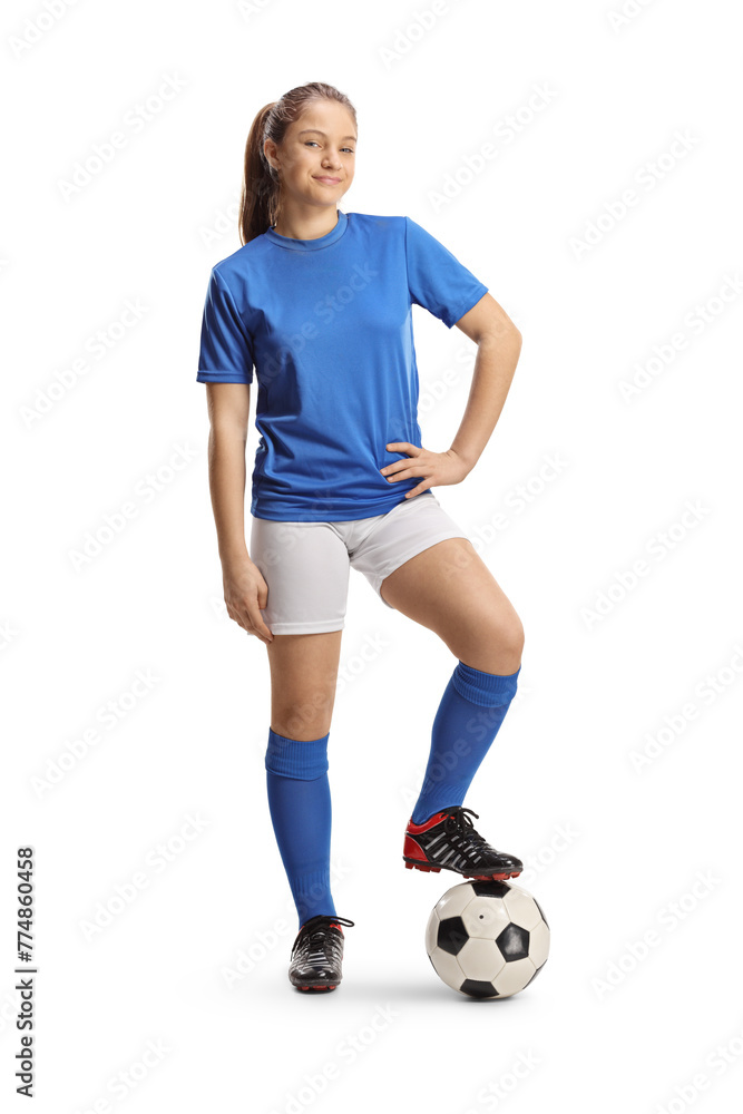 Teenage girl in a football jersey standing with a ball under foot