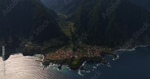 Amazing view from a drone of the town of Seixal located on the island of Madeira between the mountains on a volcanic formation overlooking the Atlantic Ocean. photo