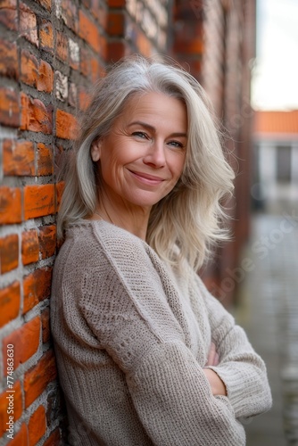 woman Leaning Against Brick Wall