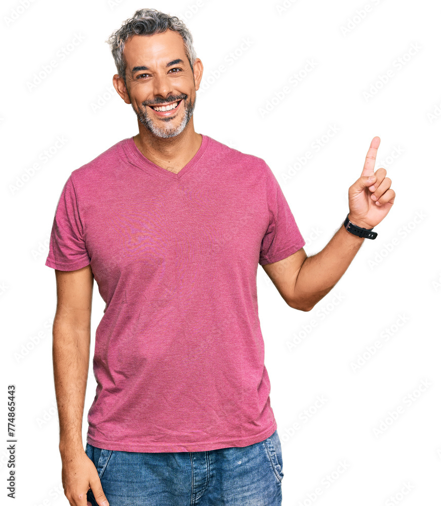 Middle age grey-haired man wearing casual clothes with a big smile on face, pointing with hand finger to the side looking at the camera. Middle age grey-haired man wearing casual clothes with a big smile on face, pointing with hand finger to the side looking at the camera.