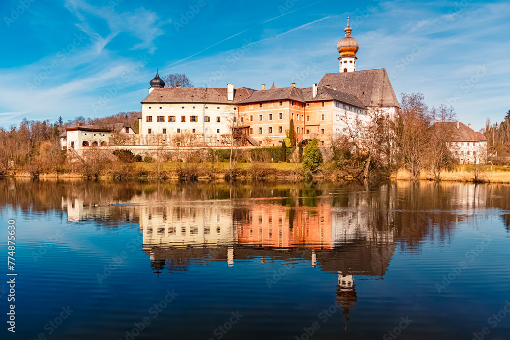 Monastery with reflections on a sunny winter day at the famous Lake Hoeglwoerther See, Hoeglwoerth, Anger, Rupertiwinkel, Berchtesgadener Land, Bavaria, Germany