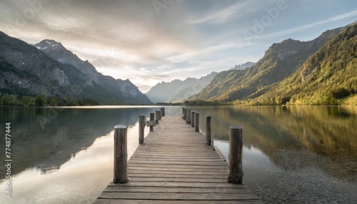wooden pier with clear lake in the alps in summer