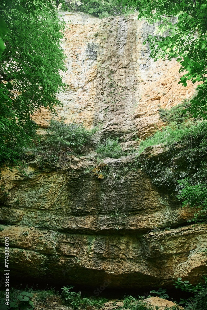 Traces of a dried-up waterfall flowing along the cliff. Mountain landscape Traces of a dried-up waterfall flowing along the cliff. Mountain landscape