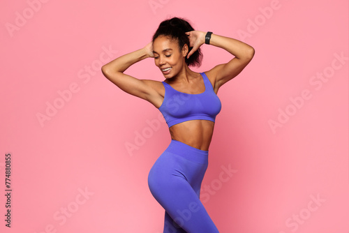 Happy woman dancing in blue sports outfit