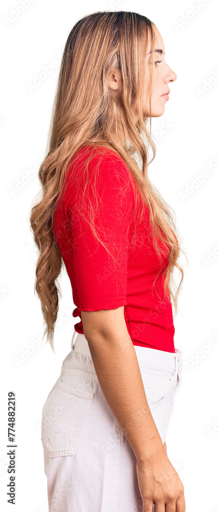Young beautiful blonde woman wearing casual clothes looking to side, relax profile pose with natural face with confident smile. Young beautiful blonde woman wearing casual clothes looking to side, relax profile pose with natural face with confident smile.