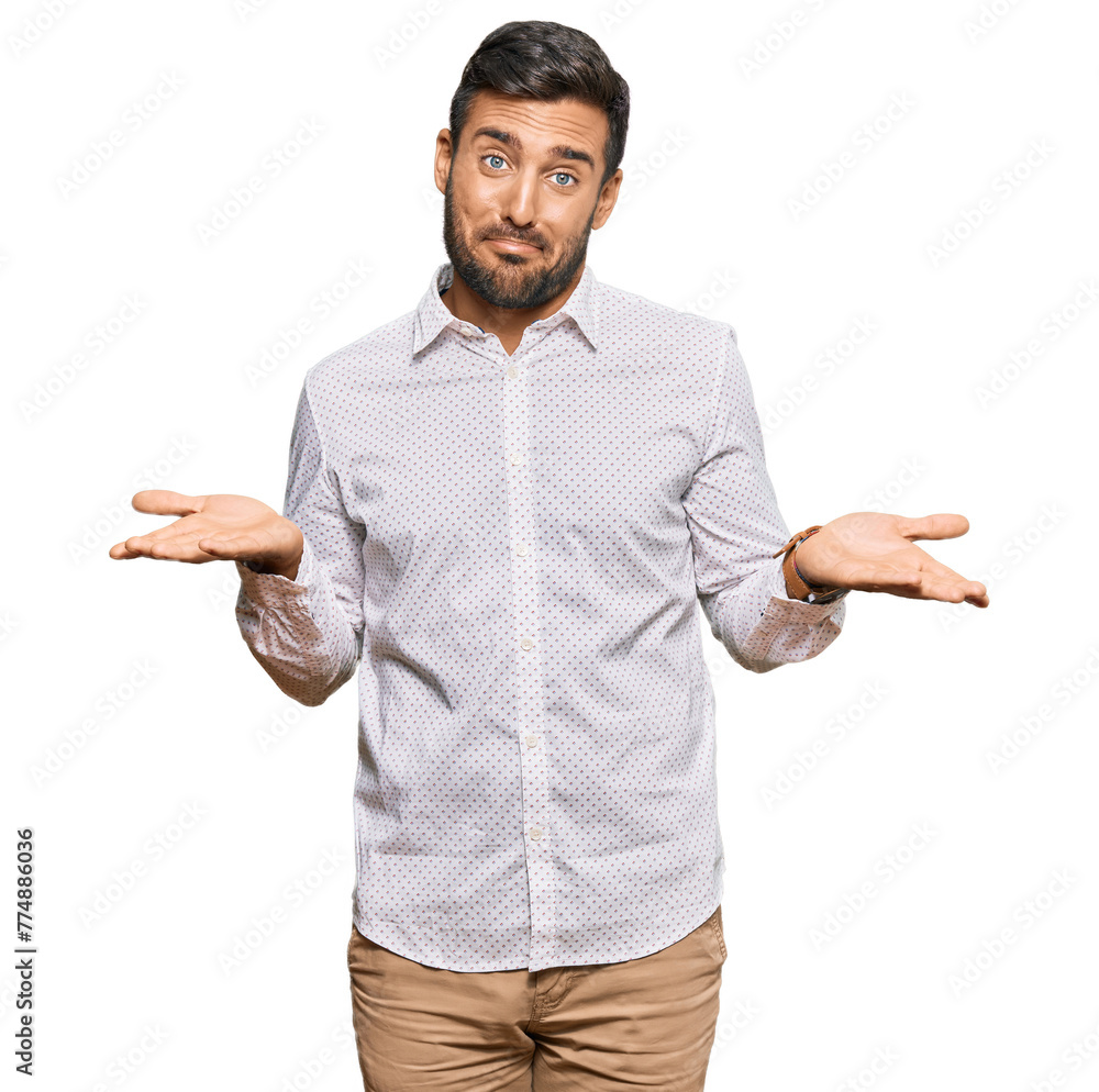 Handsome hispanic man wearing business clothes clueless and confused expression with arms and hands raised. doubt concept. Handsome hispanic man wearing business clothes clueless and confused expression with arms and hands raised. doubt concept.