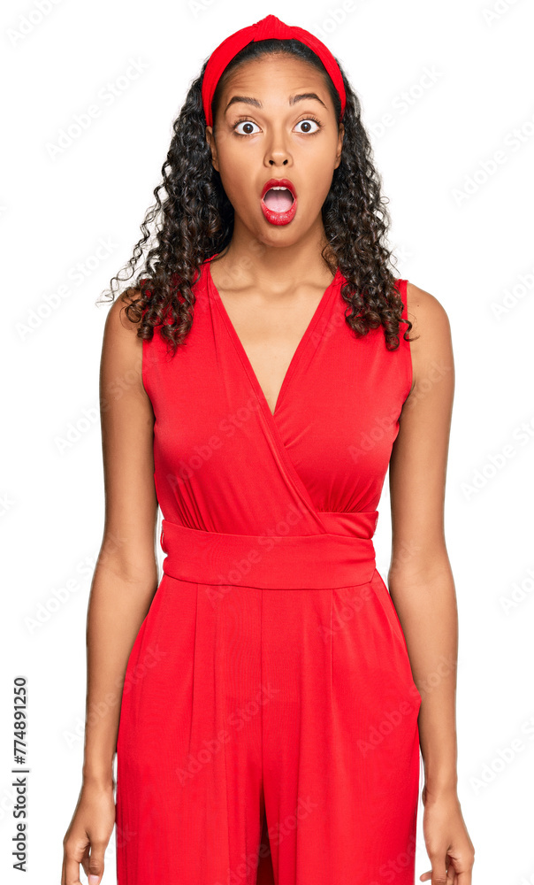 Young african american girl wearing elegant and sexy look afraid and shocked with surprise expression, fear and excited face. Young african american girl wearing elegant and sexy look afraid and shocked with surprise expression, fear and excited face.