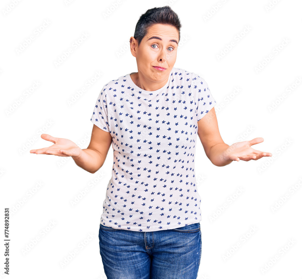 Young woman with short hair wearing casual clothes clueless and confused expression with arms and hands raised. doubt concept. Young woman with short hair wearing casual clothes clueless and confused expression with arms and hands raised. doubt concept.