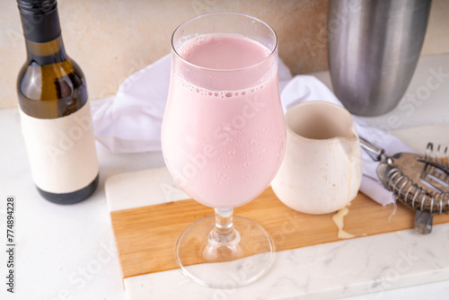 Espanhola Drink, condensed milk and red wine spanish cold cocktail with wine bottle and condensed milk  on table, copy space photo