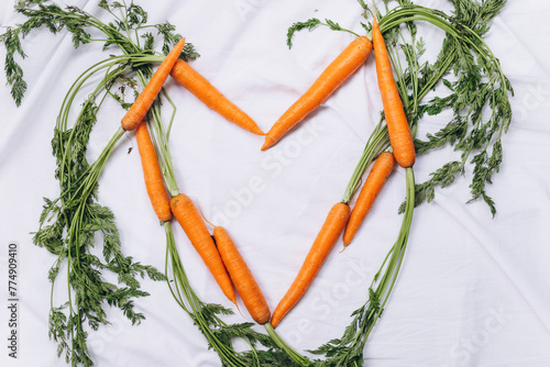 Heart made with carrots on a white material