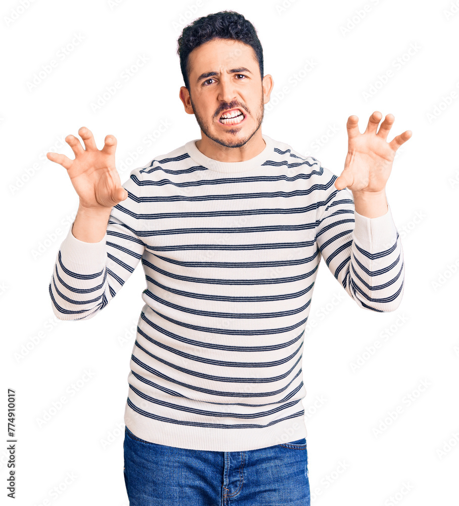 Young hispanic man wearing casual clothes smiling funny doing claw gesture as cat, aggressive and sexy expression Young hispanic man wearing casual clothes smiling funny doing claw gesture as cat, aggressive and sexy expression