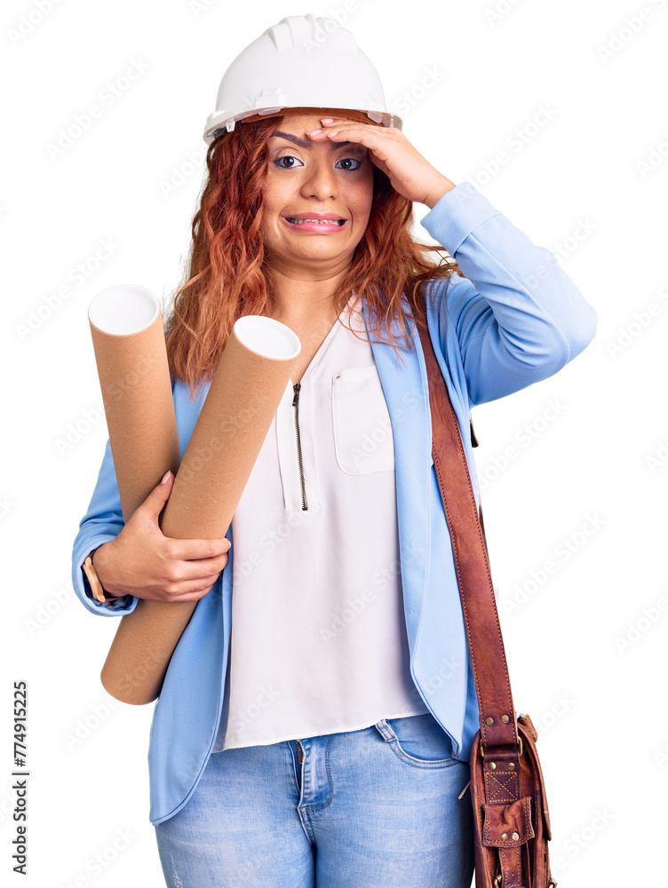 Young latin woman wearing architect hardhat holding blueprints stressed and frustrated with hand on head, surprised and angry face Young latin woman wearing architect hardhat holding blueprints stressed and frustrated with hand on head, surprised and angry face