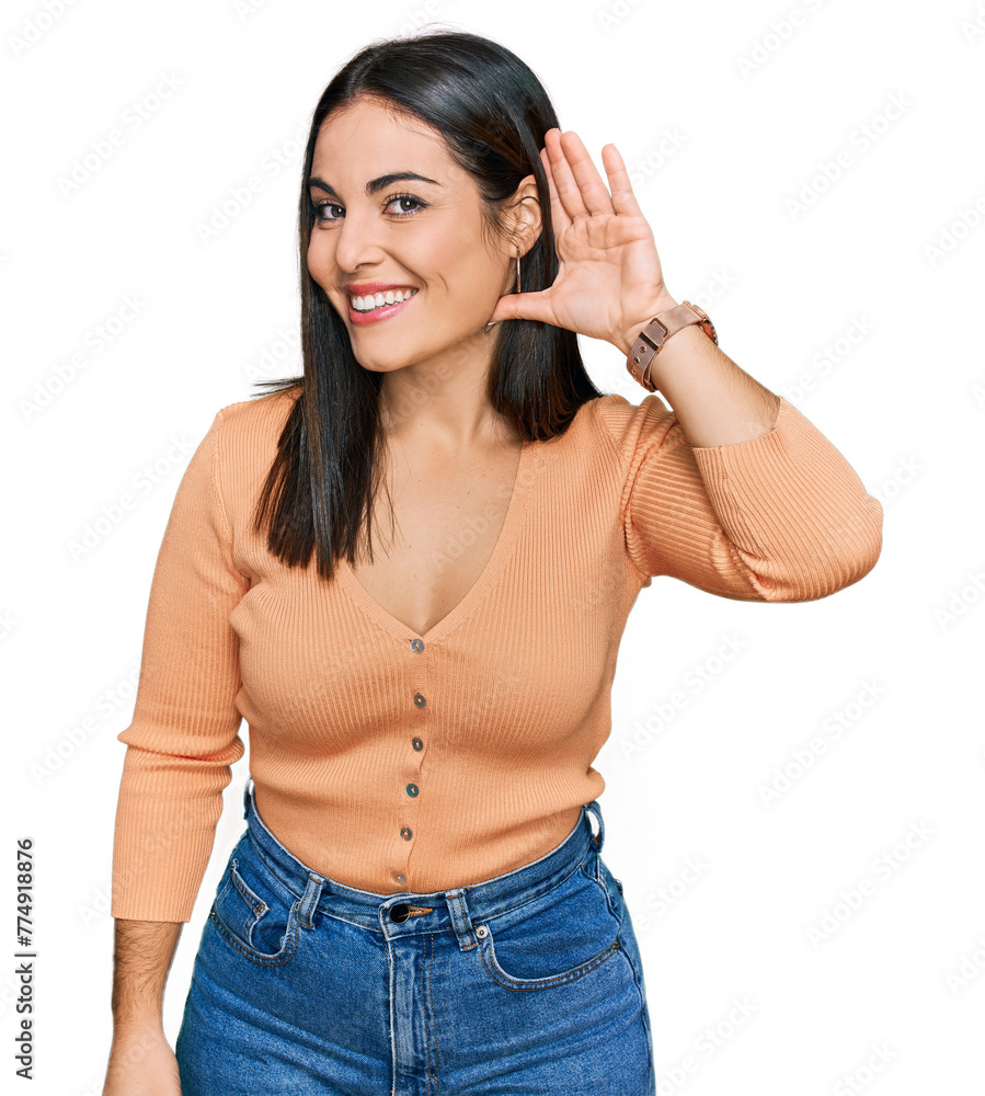 Young hispanic woman wearing casual clothes smiling with hand over ear listening an hearing to rumor or gossip. deafness concept. Young hispanic woman wearing casual clothes smiling with hand over ear listening an hearing to rumor or gossip. deafness concept.