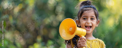 Happy Eastern Indian girl holding a megaphone © FATHOM