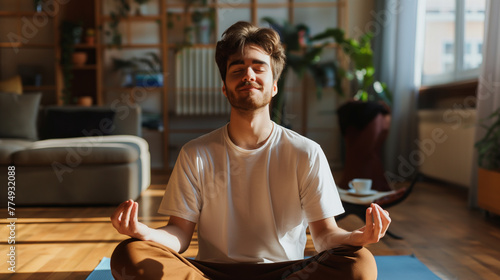 Homem feliz meditando em sua casa  photo