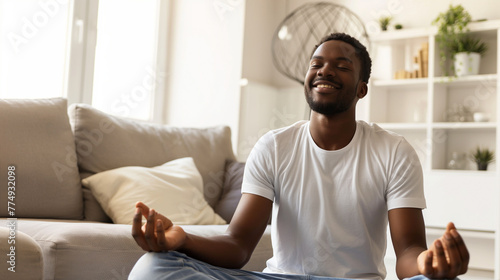 Homem feliz meditando em sua casa  photo