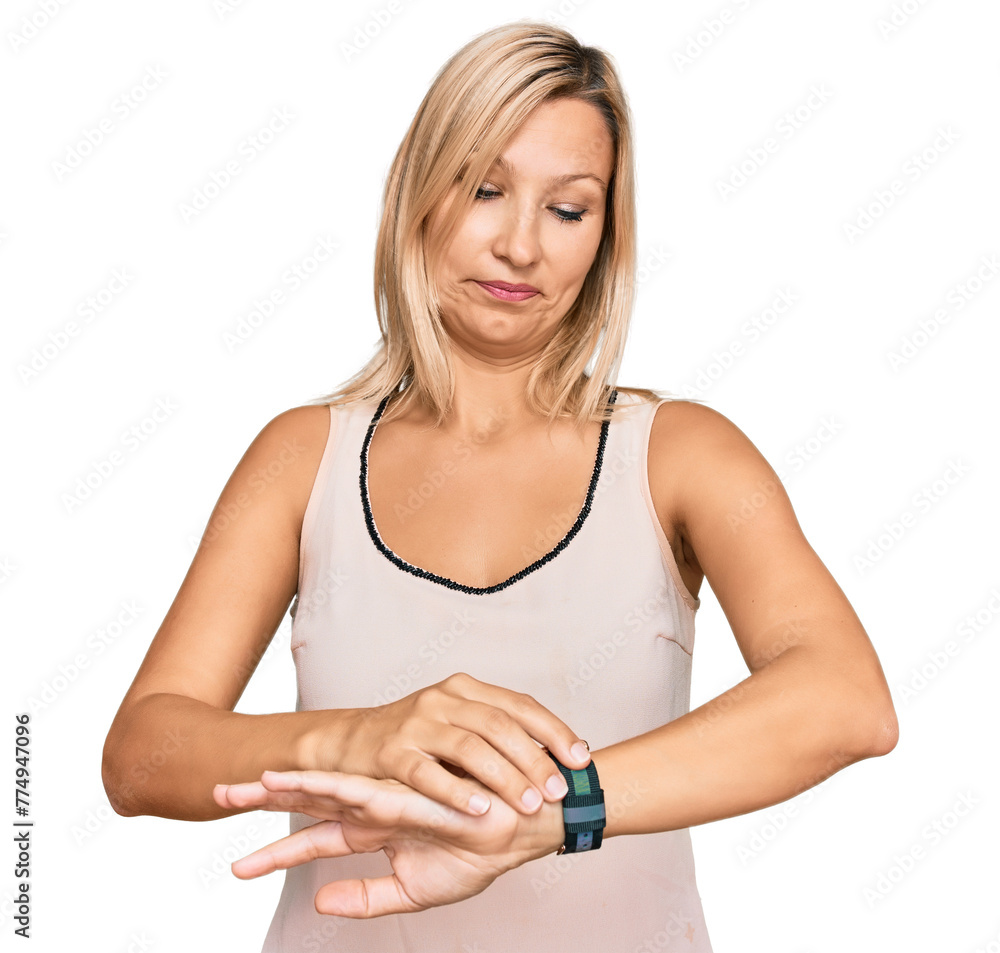 Middle age caucasian woman wearing casual clothes checking the time on wrist watch, relaxed and confident Middle age caucasian woman wearing casual clothes checking the time on wrist watch, relaxed and confident