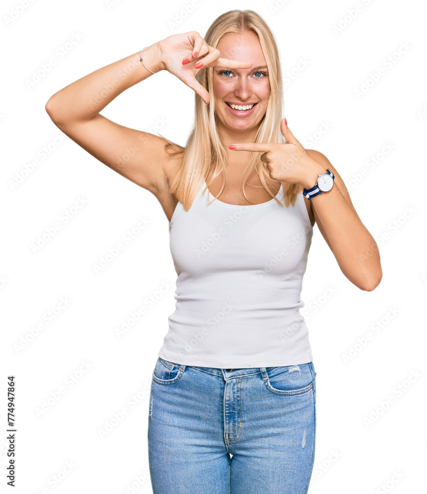 Young blonde girl wearing casual style with sleeveless shirt smiling making frame with hands and fingers with happy face. creativity and photography concept. Young blonde girl wearing casual style with sleeveless shirt smiling making frame with hands and fingers with happy face. creativity and photography concept.