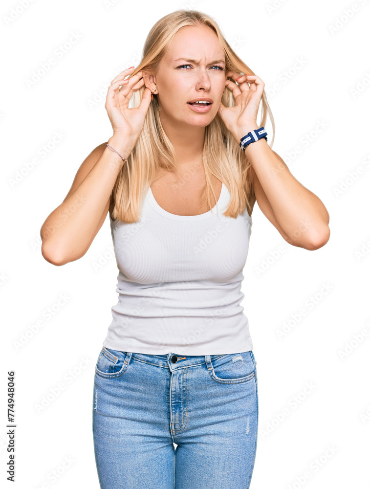 Young blonde girl wearing casual style with sleeveless shirt trying to hear both hands on ear gesture, curious for gossip. hearing problem, deaf