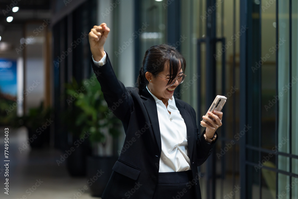 Happy excite success good news. Portrait of young Asian woman with smile. happy asian businesswoman using mobile phone. Modern office workplace