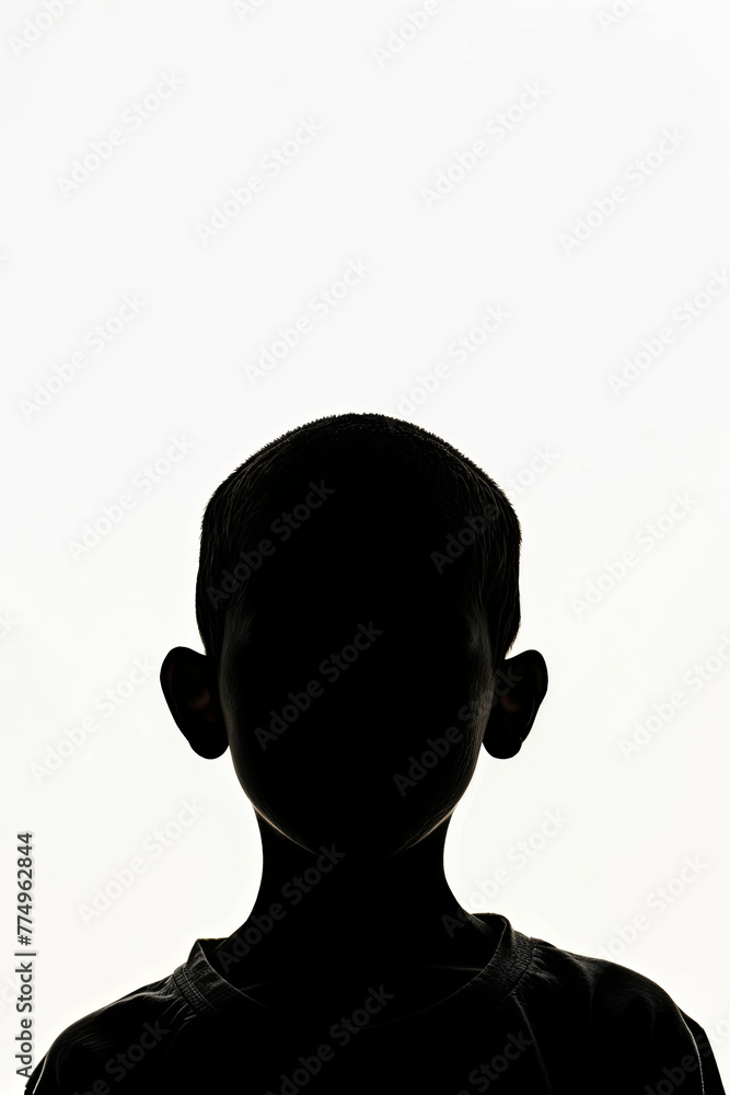 A dark silhouette figure of young boy on white background, with unclear face feature A dark silhouette figure of young boy on white background, with unclear face feature
